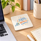 Rejoice Christian coaster styled on a bright office desk with laptop and stationery.