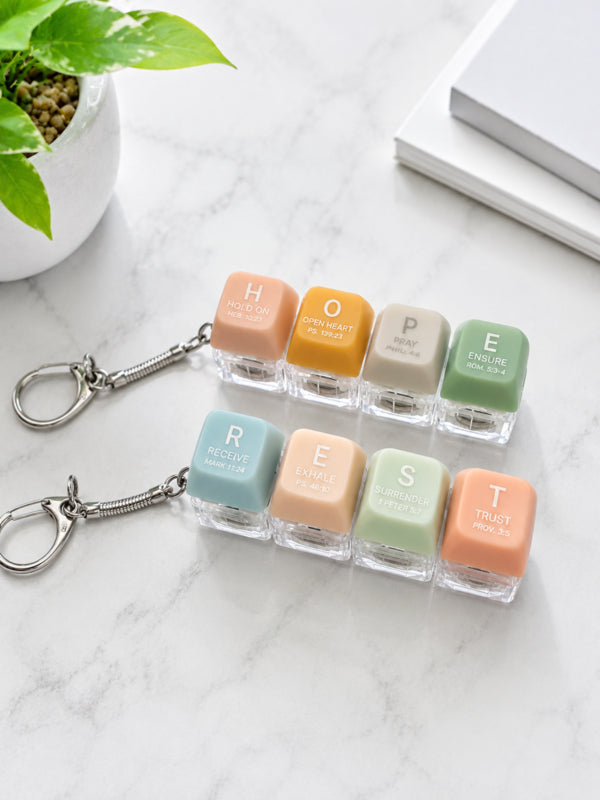 REST and HOPE pastel light-up keycap keychains displayed together