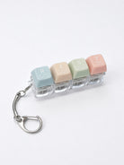 REST press-on light-up keycap keychain with pastel coloured keys spelling rest, featuring Scripture-inspired words on a bright white studio background.