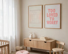 Rooted In Love Christian poster displayed beside a Too Loved To Worry poster in a soft neutral nursery