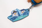 Saved by Grace Through Faith embroidered Christian keychain shaped like a paper boat with cute sailor characters attached to a bag zipper.