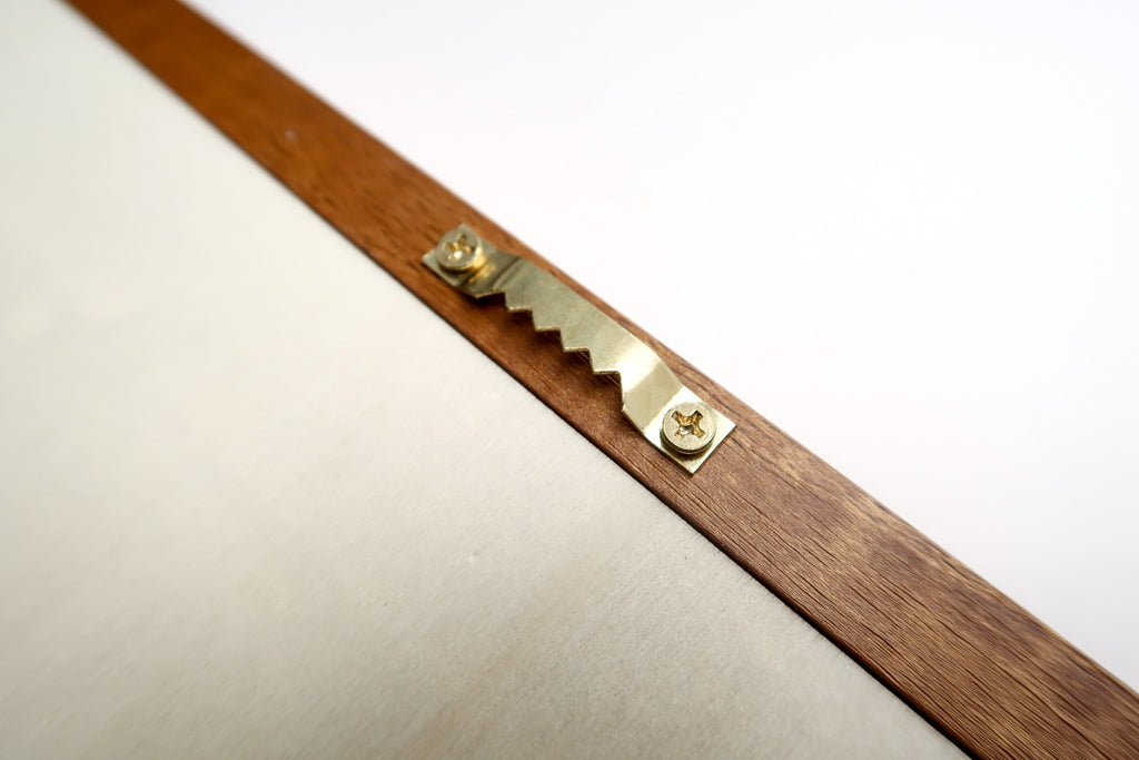 Close-up view of the back side of a wooden poster frame, showing a sturdy sawtooth hanger securely attached with screws, designed for easy wall mounting. Ideal for stable and elegant poster hanging solutions.