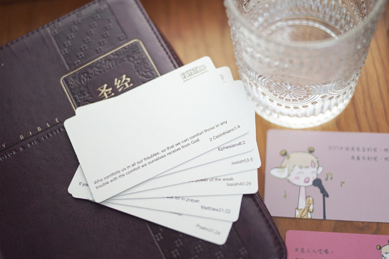 Set of scripture cards laid out on a table with a Bible, offering comfort and guidance.