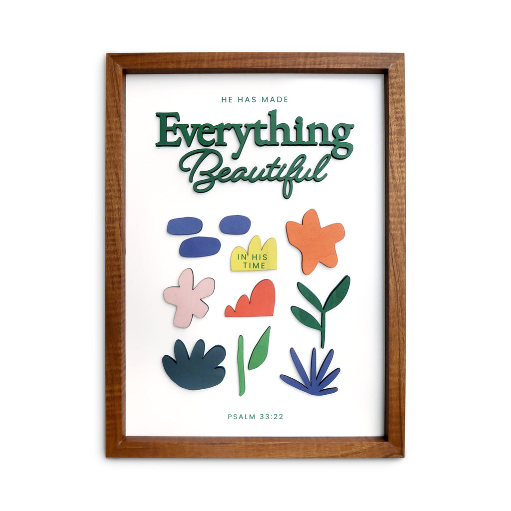 A wooden-framed wall art featuring the Bible verse "He has made everything beautiful in His time" from Psalm 33:22, adorned with colorful abstract floral designs, perfect for faith-inspired home decor.