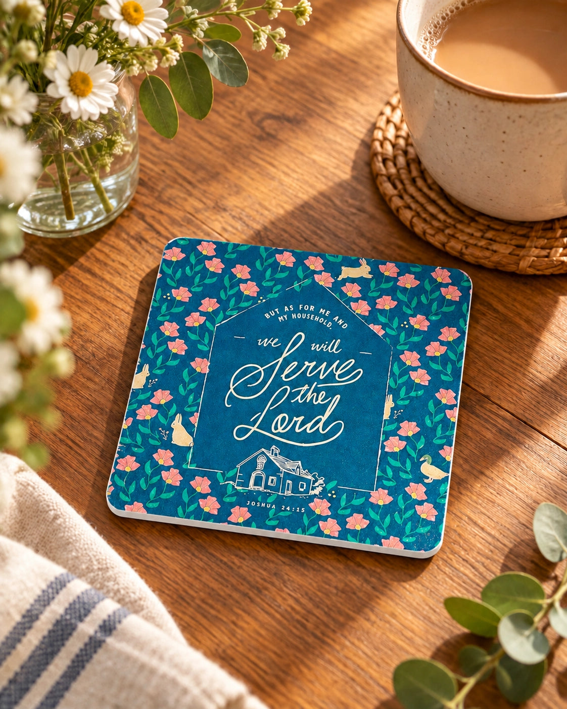 Serve the Lord Christian wooden coaster styled on a sunlit wooden table beside coffee and flowers.