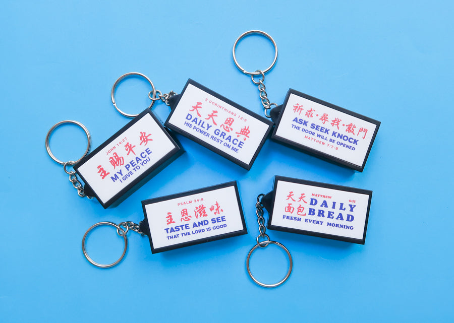 Singapore-inspired Christian lightbox keychain collection featuring My Peace, Daily Grace, Ask Seek Knock, Taste and See, and Daily Bread designs