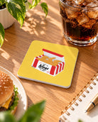 Soar on Wings Fried Chicken Wings Christian coaster on a wooden table beside a burger and cola.
