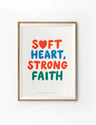 Soft Heart Strong Faith Christian poster with red, blue and green lettering on a light background