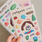 Soft Jesus sticker sheets featuring three designs: Jesus Christ, Superman, and Shepherd, each with colorful and inspirational elements.