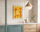 Still Growing Still Grateful poster displayed in a bright modern kitchen with warm yellow and orange tones