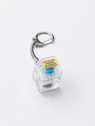 Super Blessed clear light-up keycap keychain with silver clasp on a white background
