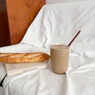 Philippians 4:19 Christian glass cup filled with latte beside bread and a book in a cosy setting