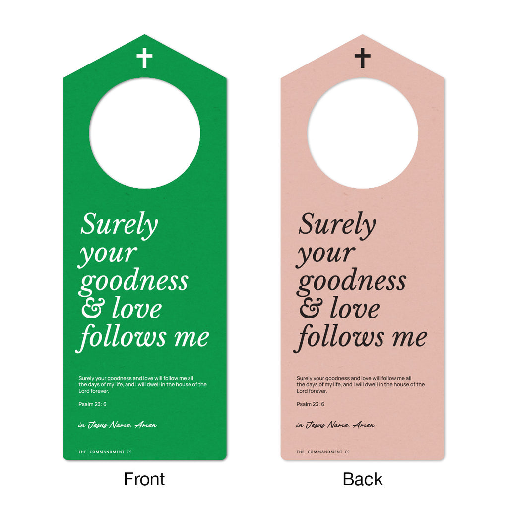 Front and back view of a Christian door hanger with the text 'Surely your goodness & love follows me,' featuring Psalm 23:6 Bible verse in green and pink color schemes.