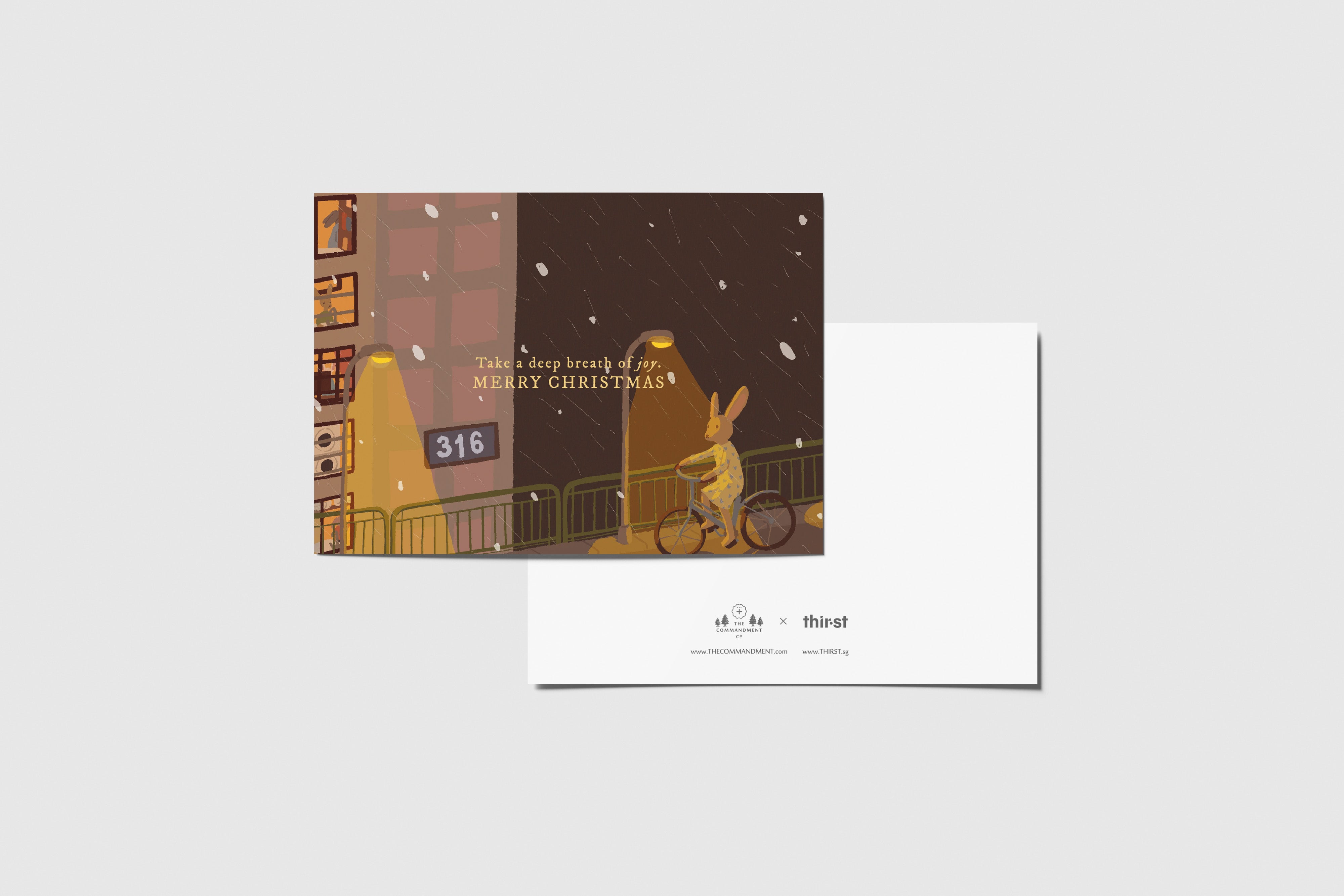 Take a Deep Breath of Joy Christmas greeting card with cosy night-time illustration, Merry Christmas message, and Thir.st x The Commandment Co branding.