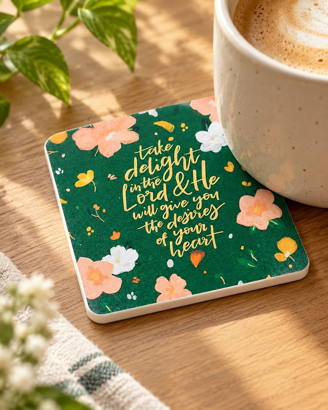 Take Delight in the Lord floral green coaster under a coffee cup on wooden table