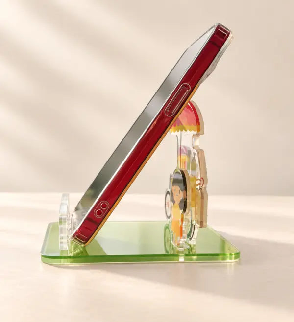 Side view of the acrylic ice cream cart phone stand supporting a smartphone