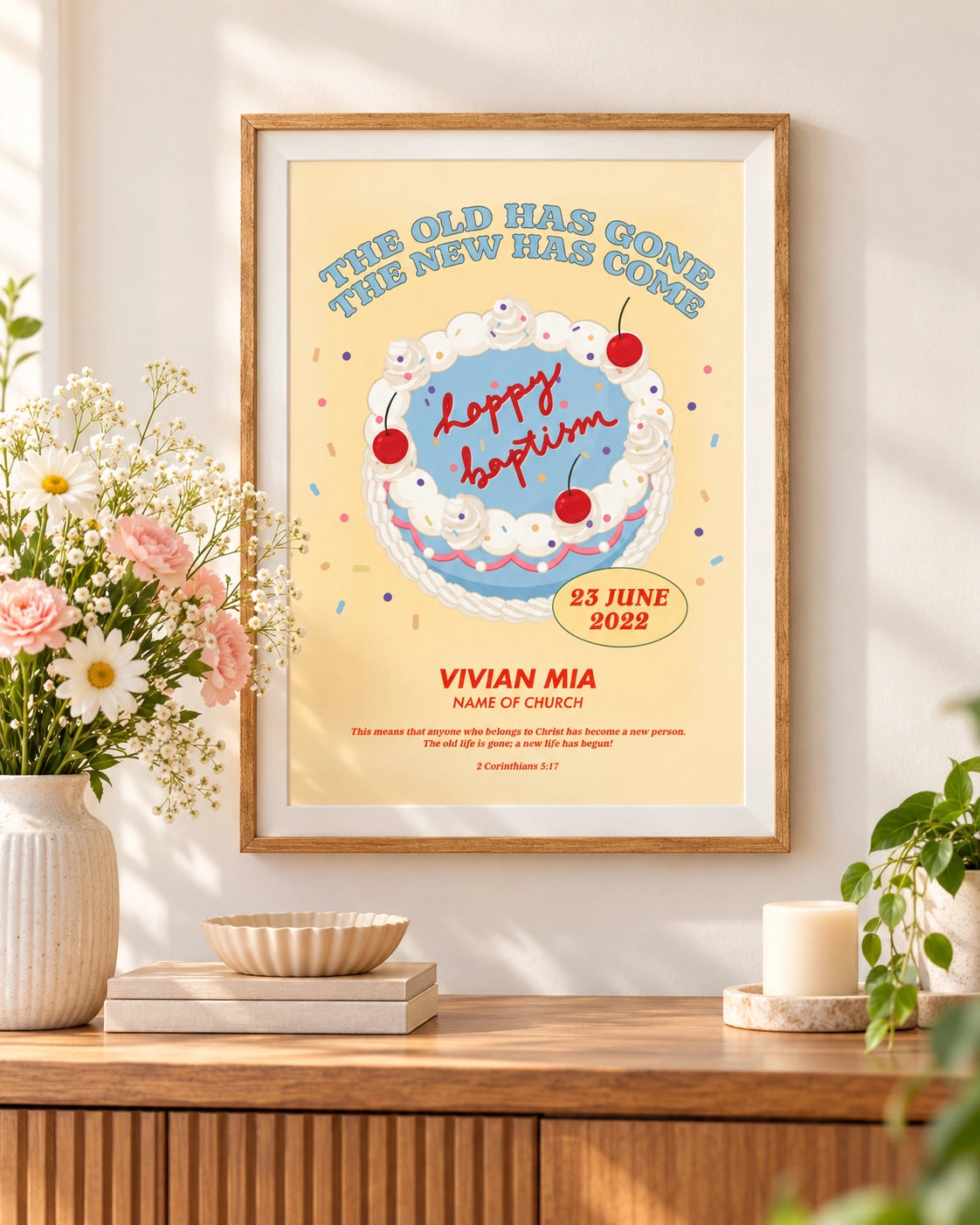 The New Has Come customisable baptism poster framed in a bright home interior with flowers.
