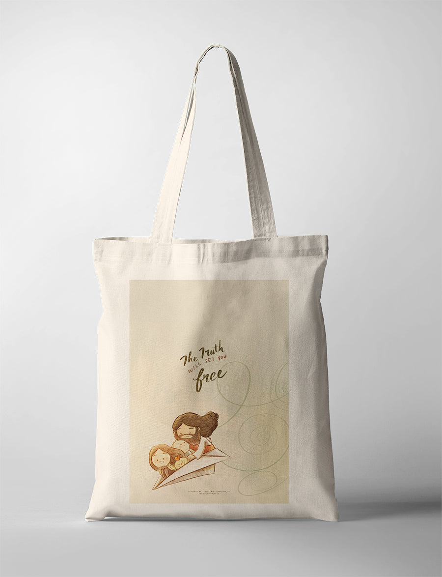 Christian tote bag showcasing Jesus with children on a paper airplane and the words “The truth will set you free,” from John 8:32.