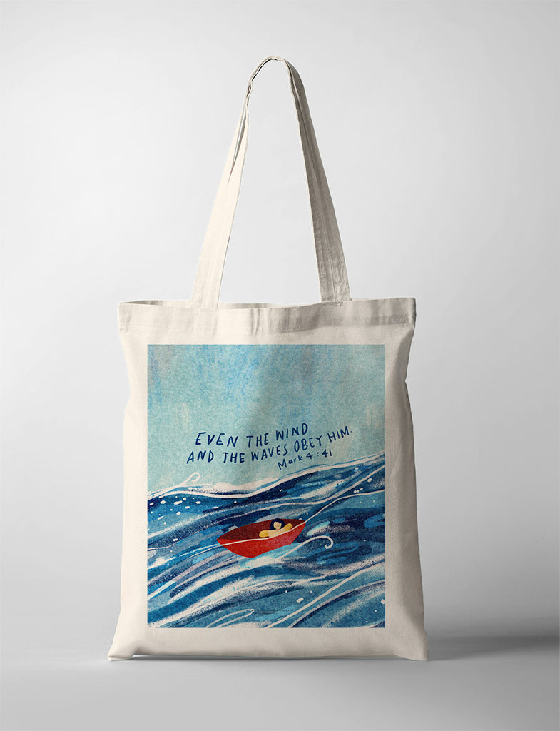 Encouraging tote bag with Mark 4:41 verse 'Even the wind and the waves obey Him' and ocean scene