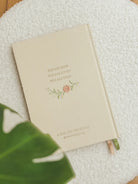 Back cover of This Little Light prayer journal with “You are seen, you are loved, you are held” text and floral embroidery