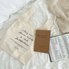 Today is gonna be a wonderful day A5 notebook, an inspirational tote bag with a faithfulness message, and an open Bible on a cozy white bed, reflecting simple happiness and encouragement.