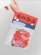 Sealed mini Chinese New Year couplet sticker pack showing festive red blessing designs