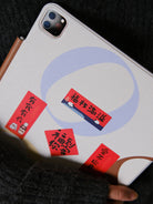 Mini Chinese New Year couplet stickers applied on tablet case for festive CNY decoration