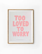 Too Loved to Worry Christian poster with bold pink lettering on a soft white background