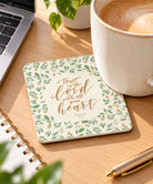 Trust in the Lord Christian coaster styled on an office desk with coffee and stationery.
