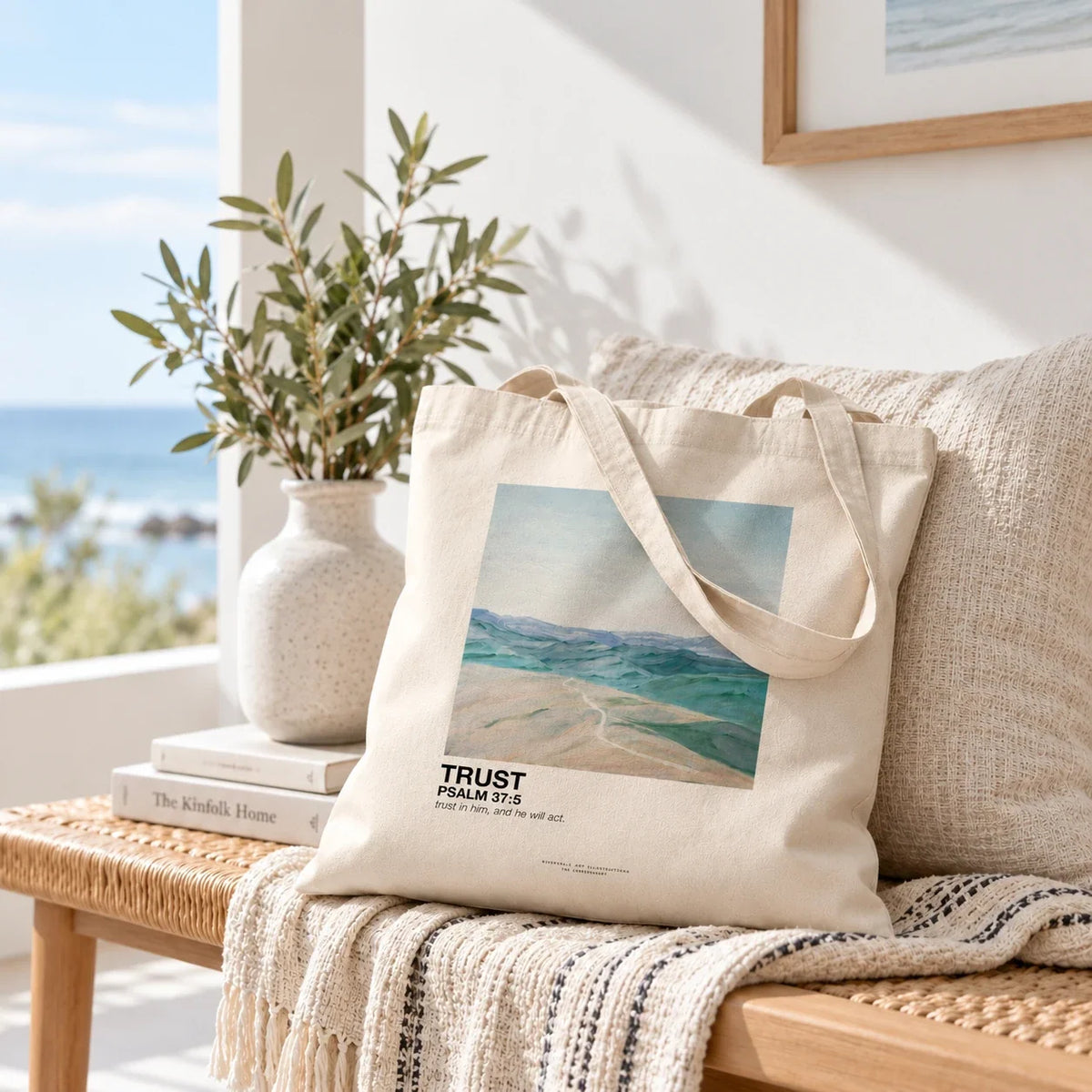 Trust Psalm 37:5 canvas tote with straps falling against cushion in coastal living room