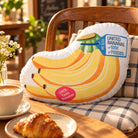United Banana plush toy styled on a cafe chair