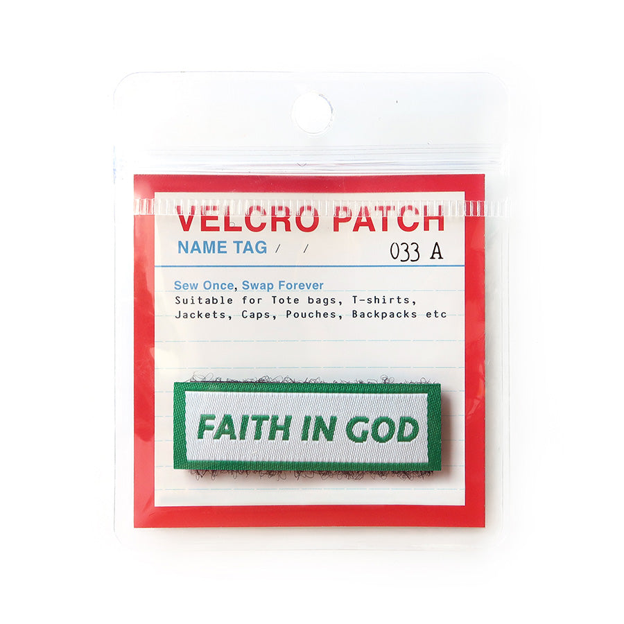 Velcro tag with the phrase 'Faith in God' in green text on a white background with a green border, a Christian faith accessory for apparel and bags