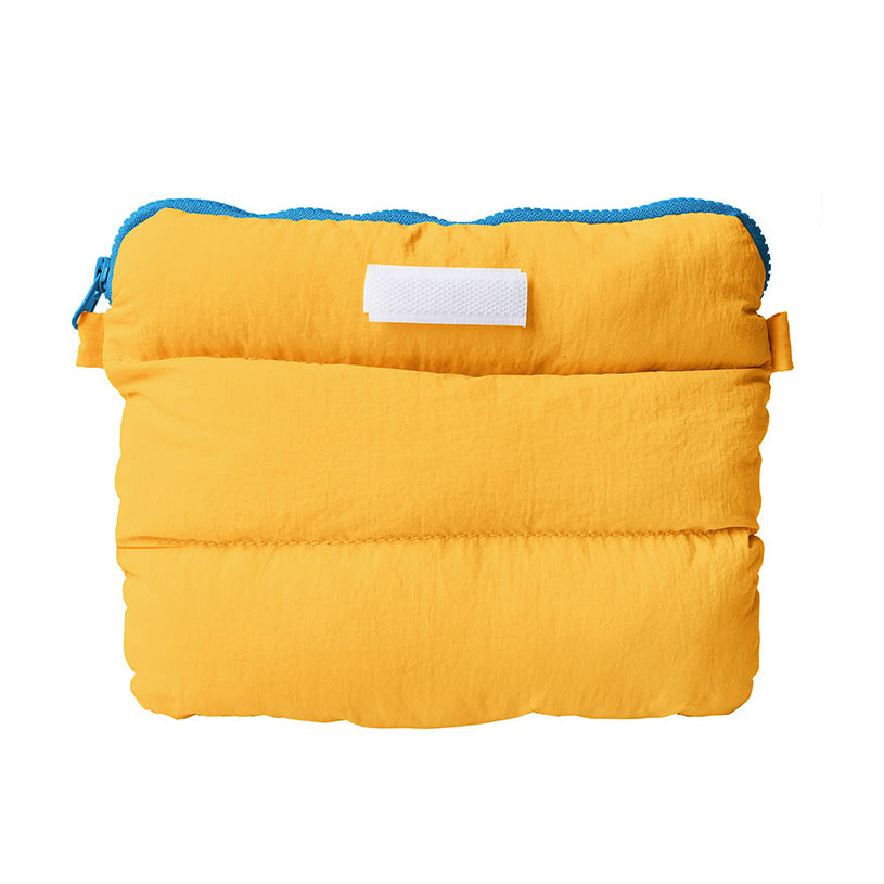 A vibrant yellow Pong Pong Bag with a blue zipper, showcasing its compact and versatile design for everyday use.