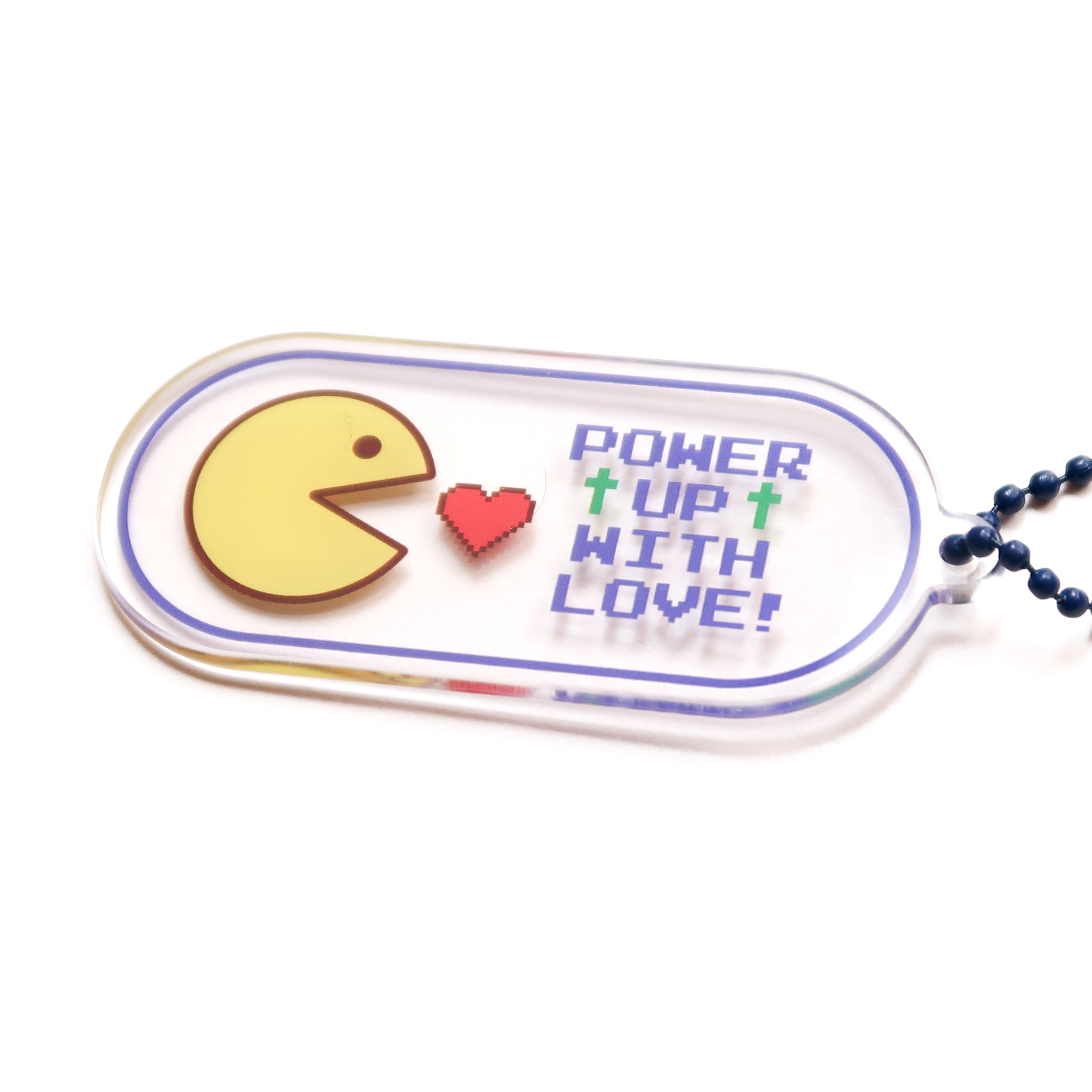Acrylic video game keychain featuring the retro “Power Up with Love” text and pixel art, 7 cm x 3 cm, with a blue ball-chain