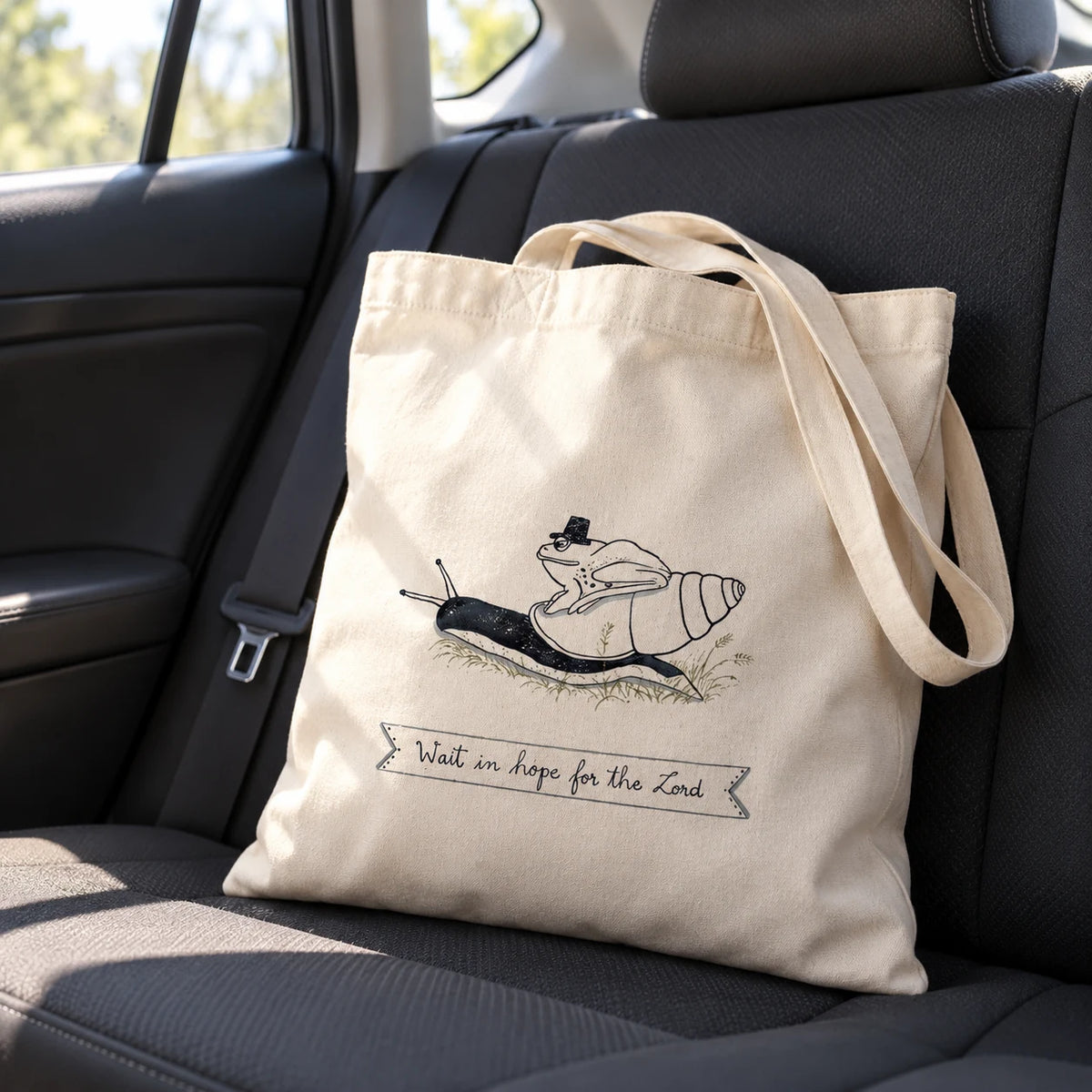 Wait in Hope illustrated Christian tote bag resting on the back seat of a car
