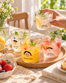 We Are One mini glass cups with colourful drinks styled on a sunny table