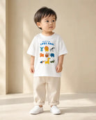 Toddler wearing the white Welcome to the Love Zoo kids’ T-shirt with animal illustrations