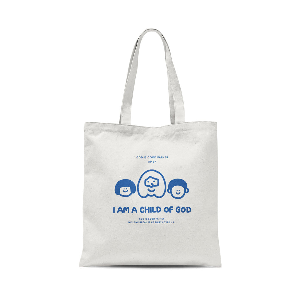 White tote bag featuring the text 'I am a child of God' with illustrations of three faces and the phrases 'God is Good Father' and 'We love because He first loved us.'