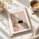 Who Is Jesus Christian book styled on a sunlit table beside a cup of coffee.