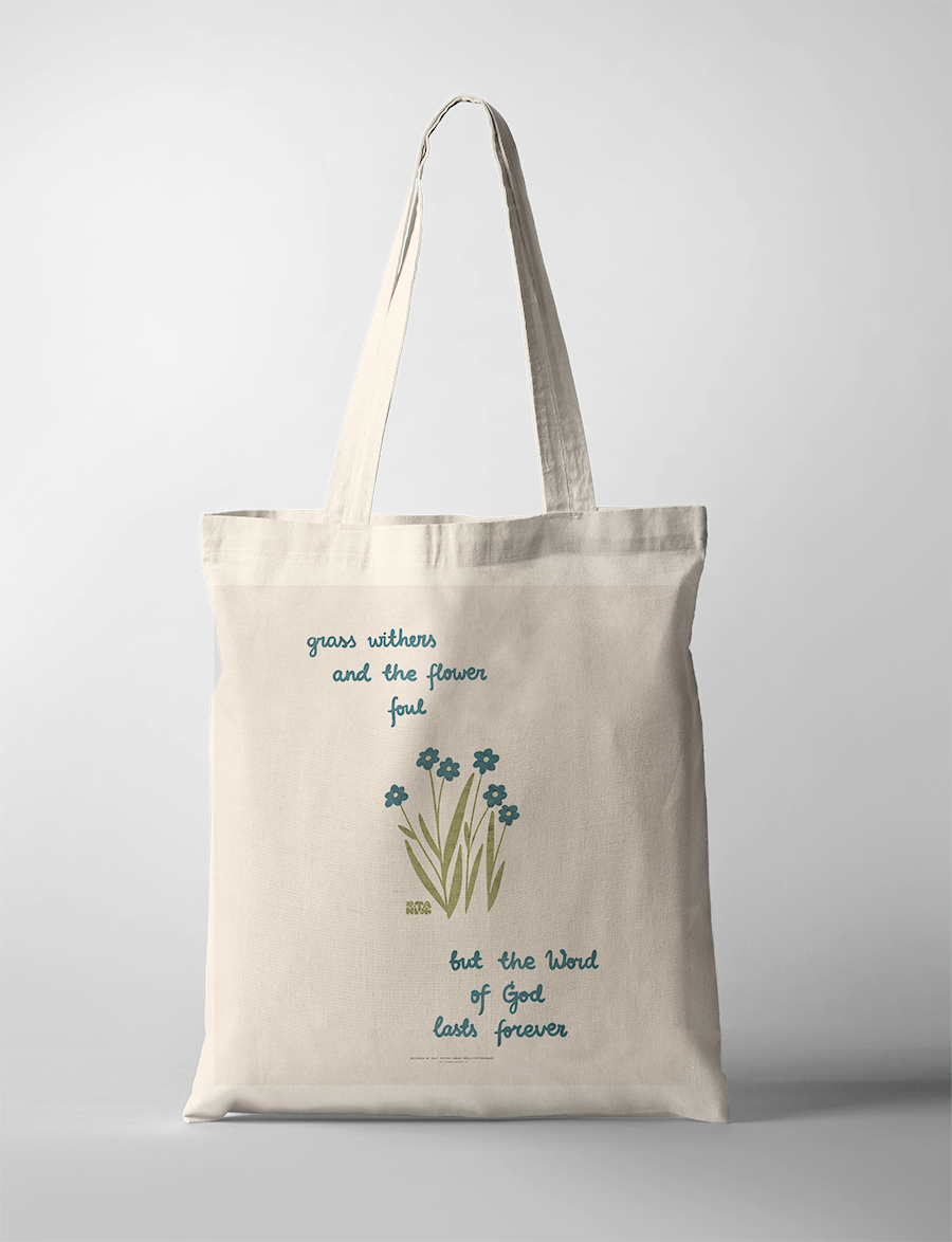 Inspirational Christian tote bag  with the words "grass withers and the flower fall, but the Word of God lasts forever," featuring simple blue flowers and green grass, reflecting faith and simple happiness.