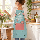 Lifestyle photograph of a woman arranging flowers in the You Are Fearfully and Wonderfully Made apron.