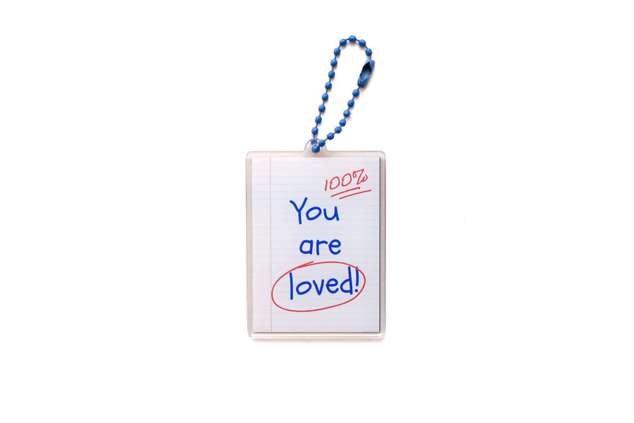 Back view of Jotter Book acrylic keychain featuring handwritten “You are loved!” reminder
