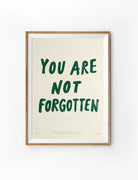 You Are Not Forgotten Christian poster with bold dark green hand-lettered text on a warm cream background