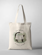 Christian tote bag featuring “Your testimonies are a joy to my heart” with a black cat holding a Good News newspaper