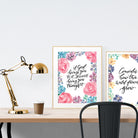 A3 beautiful calligraphy poster placed standing next to a smaller A4 sized calligraphy poster on a wooden table. Modern home interior design ideas.