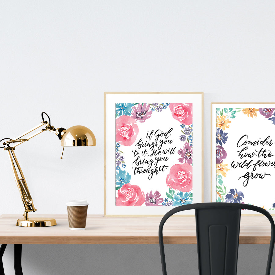 A3 beautiful calligraphy poster placed standing next to a smaller A4 sized calligraphy poster on a wooden table. Modern home interior design ideas.