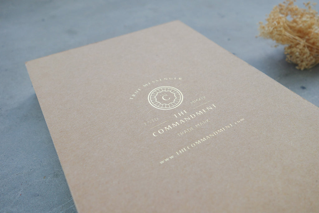 The logo on the back of the notebook is gold stamped with the commandment co logo and website