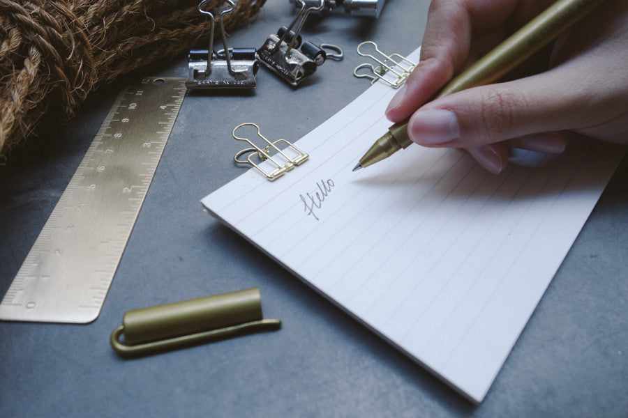 Close up of smooth writing by the timeless brass pen. Ageless gift that will impress anyone special.