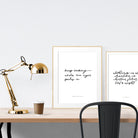 A3 beautiful calligraphy poster placed standing next to a smaller A4 sized calligraphy poster on a wooden table. Modern home interior design ideas.