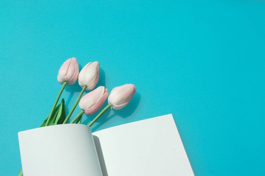 Blank notebook with crisp white pages and tulips